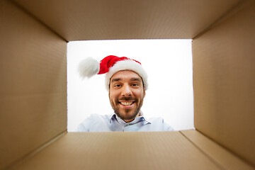 Image showing happy man opening parcel box or christmas gift