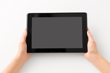 Image showing close up of hands with black tablet computer