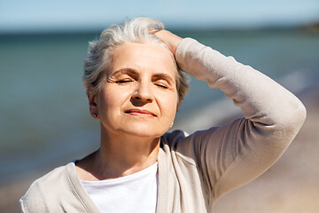 Image showing portrait of senior woman enjoying sun on beach