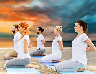 Image showing people making yoga in hero pose outdoors