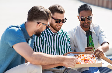 Image showing male friends eating pizza with beer on street