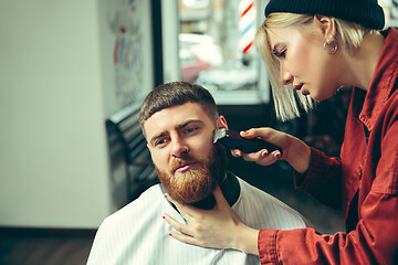 Image showing Client during beard shaving in barber shop