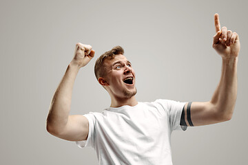 Image showing Winning success man happy ecstatic celebrating being a winner. Dynamic energetic image of male model