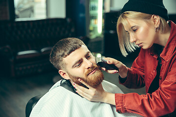 Image showing Client during beard shaving in barber shop