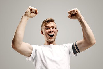 Image showing Winning success man happy ecstatic celebrating being a winner. Dynamic energetic image of male model