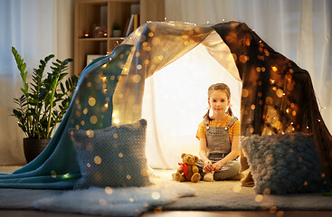 Image showing little girl with toys in kids tent at home