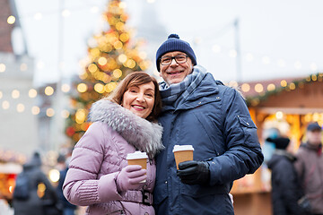 Image showing senior couple with coffee at christmas market