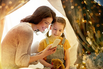 Image showing happy family with smartphone in kids tent at home