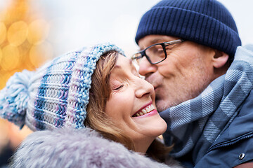 Image showing close up of happy senior couple kissing in winter