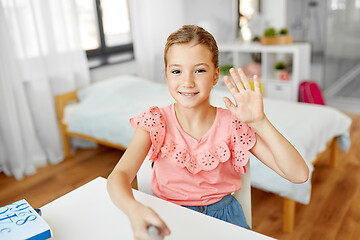 Image showing happy girl taking selfie and waving hand at home