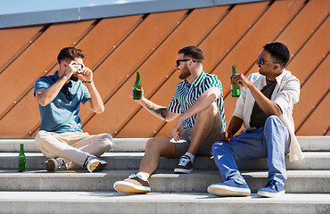 Image showing man photographing friends drinking beer on street