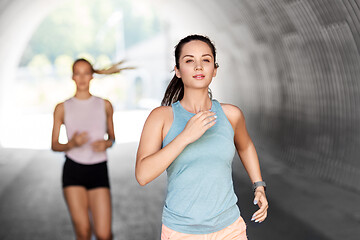 Image showing young women or female friends running outdoors