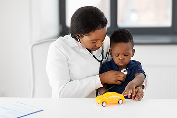 Image showing doctor with stethoscope and baby patient at clinic