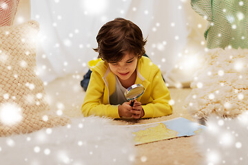 Image showing boy with magnifier and map in kids tent at home