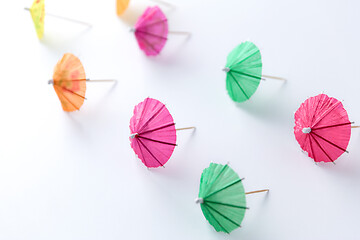 Image showing cocktail umbrellas on white background