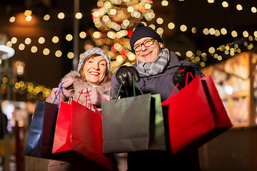 Image showing old couple at christmas market with shopping bags