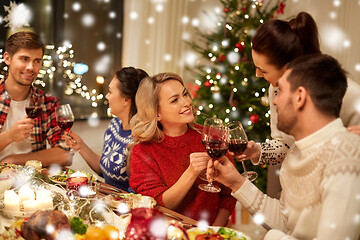 Image showing friends celebrating christmas and drinking wine