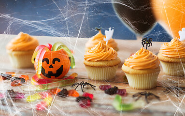 Image showing halloween party cupcakes and candies on table