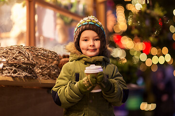 Image showing happy boy with cup of tea at christmas market