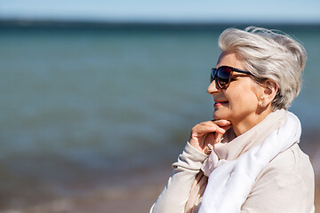 Image showing portrait of senior woman in sunglasses on beach