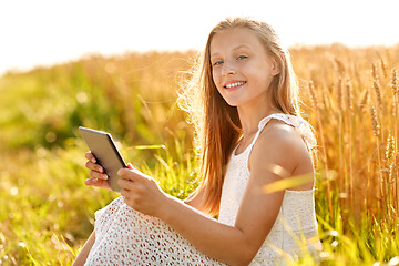 Image showing smiling with tablet computer on cereal field