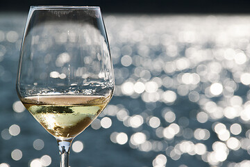 Image showing Close-up wineglass and blue sea