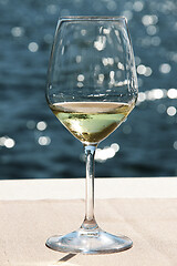 Image showing Close-up wineglass and blue sea