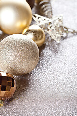 Image showing Golden decorations closeup on glitter background.