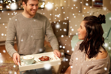 Image showing happy couple with food on tray at home