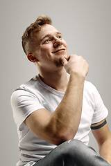 Image showing The happy businessman standing and smiling against gray background.