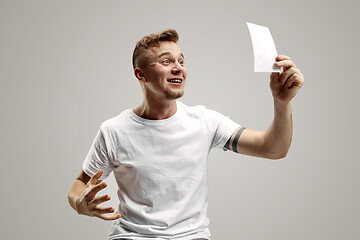 Image showing Young man with a surprised expression won a bet