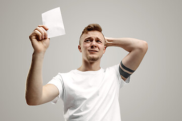 Image showing Young man with a surprised expression won a bet