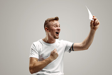 Image showing Young man with a surprised expression won a bet