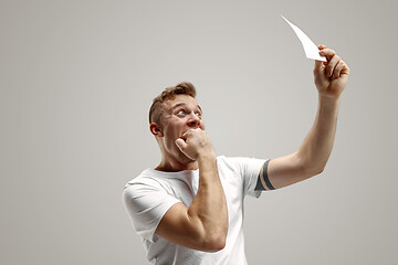 Image showing Young man with a surprised expression won a bet