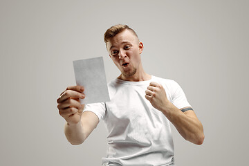 Image showing Young man with a surprised expression won a bet