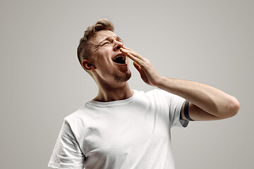 Image showing Young man with beard yawning