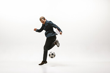 Image showing Businessman with football ball in office