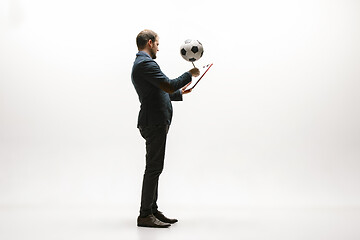 Image showing Businessman with football ball in office