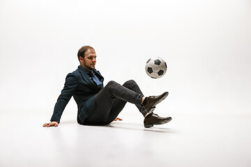 Image showing Businessman with football ball in office