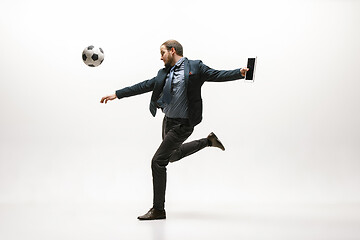 Image showing Businessman with football ball in office