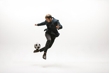 Image showing Businessman with football ball in office