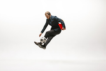 Image showing Businessman with football ball in office