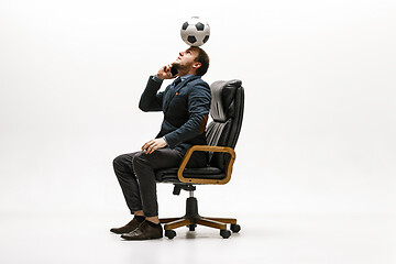 Image showing Businessman with football ball in office