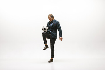 Image showing Businessman with football ball in office