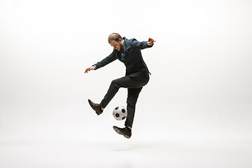 Image showing Businessman with football ball in office