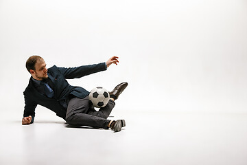 Image showing Businessman with football ball in office