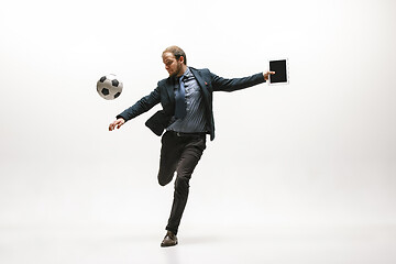 Image showing Businessman with football ball in office