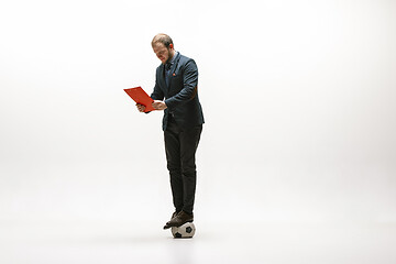 Image showing Businessman with football ball in office