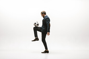 Image showing Businessman with football ball in office