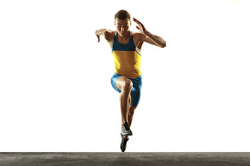 Image showing Young caucasian man running or jogging isolated on white studio background.